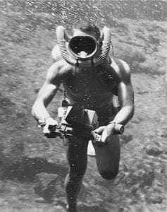 Early scuba diver with underwater camera